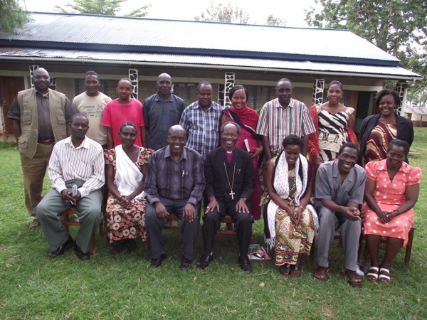 Bishop Mwita with staff of Mogabiri Farm Extension Centre, after meeting