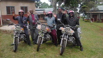 Bishop Mwita with priests on the motorcycles donated in 2016