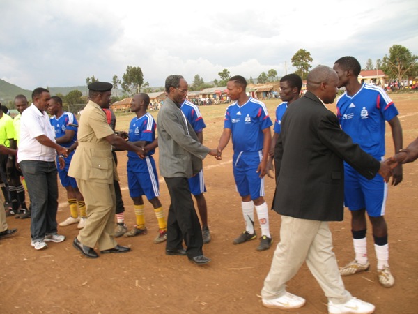 Mr Kabohola (in black jacket), greetings the players of Mafundi FC & Shirati before the inaugural match on 27 August.