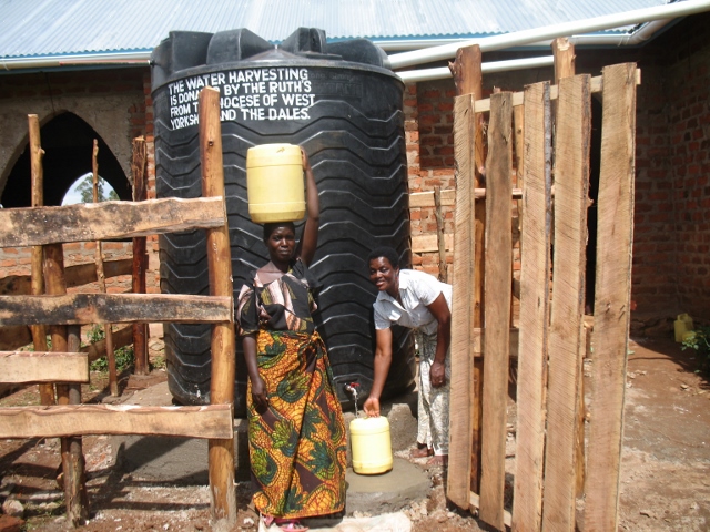 Women from the community collecting water at Bugumbe Church